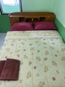 a bed with a bedspread with bears on it at Peace of Love Pai in Pai