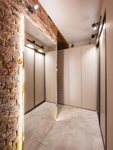 a row of wardrobes in a room with a brick wall at Caps Hotel на Остоженке in Moscow