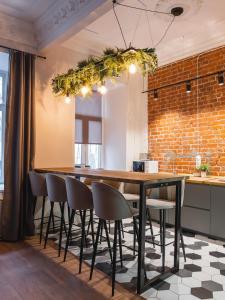 a kitchen with a large wooden table and chairs at Caps Hotel на Остоженке in Moscow