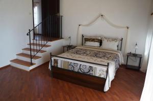 a bedroom with a bed and a staircase at Villa Bignonia in Varna City