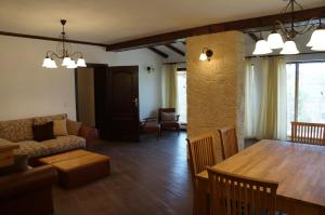 a living room with a couch and a dining room table at Villa Bignonia in Varna City