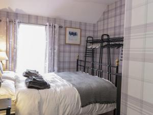 a bedroom with a bed and a window at Castle Keep in Berwick-Upon-Tweed
