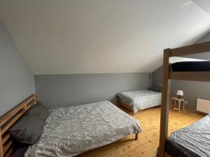 a bedroom with two beds and a bunk bed at Guesthouse Sidrabozoli in Līči