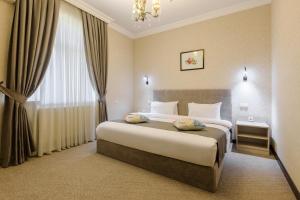 a hotel room with a bed and a window at Navruz Hotel Tashkent in Tashkent +29 photos