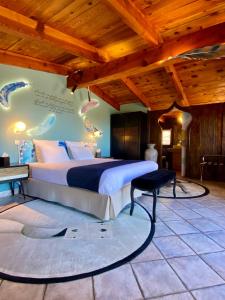 - une chambre avec un lit et un plafond en bois dans l'établissement Hôtel Domaine A Flatta, à Calenzana