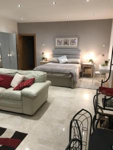 a large bedroom with a bed and a couch at Luxurious Studio Apartment in Fahan Co Donegal in Fahan