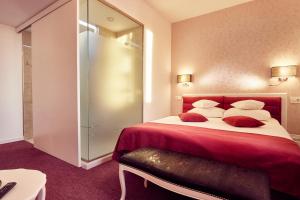 a bedroom with a large bed with red sheets and pillows at Continental Forum Sibiu in Sibiu