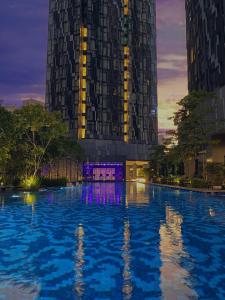 a building with a pool of water in front of it at Star at KLCC in Kuala Lumpur