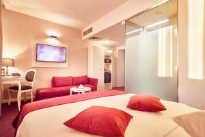 a hotel room with a bed and a red couch at Continental Forum Sibiu in Sibiu +37 photos
