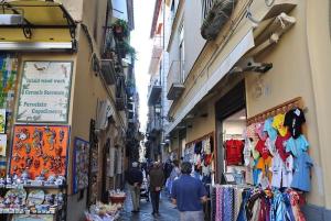 a group of people walking down a narrow street with shops at Sunshine House in Sorrento +8 photos