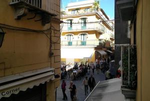 a group of people walking down a street next to a building at Sunshine House in Sorrento
