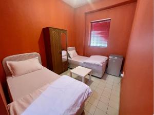 a small room with two beds and a window at California Hostel Dubai Beach in Dubai