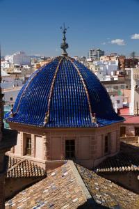 a building with a blue roof on top of a city at Russafa Youth Hostel in Valencia