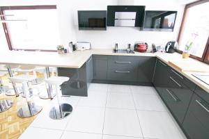 a kitchen with green cabinets and white tile floors at Familienzimmer in Neumarkt in der Oberpfalz