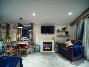 a living room with a couch and a fireplace at Bayfield in Lamplugh