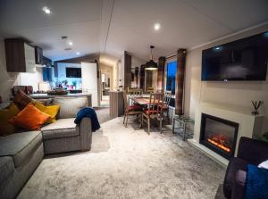 a living room with a couch and a fireplace at Bayfield in Lamplugh