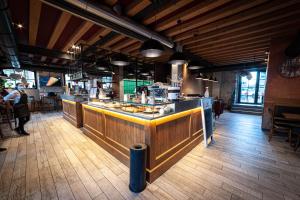 a restaurant with a counter with food on it at NUOVA FILANDA Rooms and More in Valdobbiadene