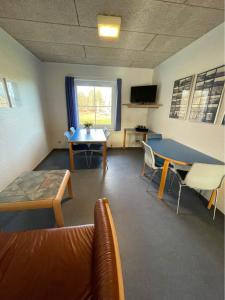 a living room with a ping pong table and a couch at Roslev Vandrerhjem-Hostel in Roslev