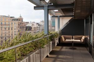 a balcony with a bench and a view of the city at Hotel Royal Passeig de Gracia in Barcelona