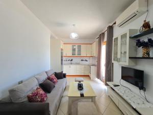 a living room with a couch and a table at Guesthouse Emanuel in Ksamil