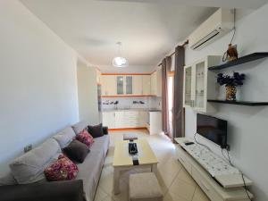 a living room with a couch and a table at Guesthouse Emanuel in Ksamil