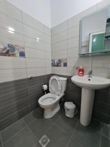 a bathroom with a toilet and a sink at Guesthouse Emanuel in Ksamil