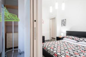 a small bedroom with a bed and a closet at Casa dell'Ulivo in Aci Bonaccorsi