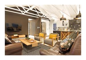 a living room with a couch and a table at Villa Lyrique in Cape Town +33 photos
