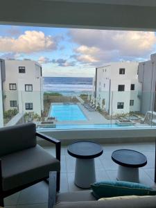 a view of the ocean from the balcony of a hotel at East Coast Beachfront Luxury - Eastern Blue Apartments in Poste Lafayette