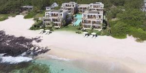 an aerial view of a resort on a beach at East Coast Beachfront Luxury - Eastern Blue Apartments in Poste Lafayette