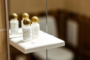 a shelf with two bottles of moisturizers on it at Armada Comfort Hotel in Orenburg