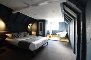 a bedroom with a large bed and a large window at Whitehouse Rye in Rye