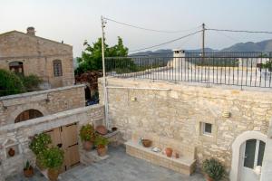 a stone building with potted plants on a patio at Margarita Mansion, with private heated pool! in Kalandares