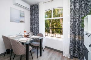 a dining room with a table and chairs and a window at Espanatour VIOLETAS in Orihuela