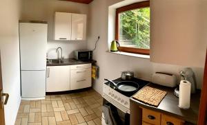 a small kitchen with a sink and a refrigerator at Ferienwohnung Monteuerswohnung am Bauernhofweg in Lohmar nahe S-Bahnhof in Lohmar