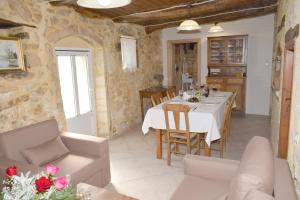 a kitchen and dining room with a table and chairs at Margarita Mansion, with private heated pool! in Kalandares