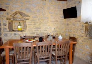 a dining room with a wooden table and chairs at Margarita Mansion, with private heated pool! in Kalandares