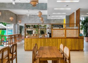 a dining room with a wooden table and chairs at Outpost Weligama Beachfront in Weligama