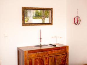 a mirror on top of a dresser in a room at Fewo Papst Nordborchen in Nordborchen