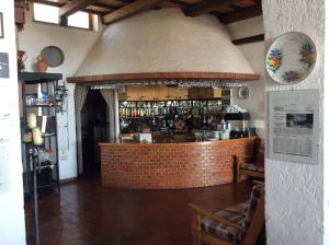 a bar in a restaurant with a brick counter at B&B Loreblick in Loreto Aprutino