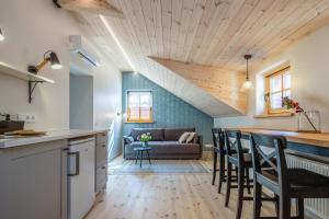 a kitchen and living room with a couch at B2 Apartments in Klaipėda
