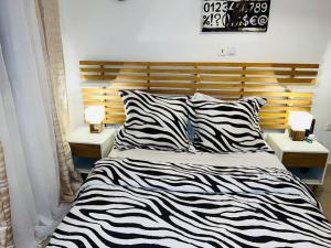Кровать или кровати в номере Appartement cosy 4 bonapriso