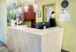a reception desk in a store with a person in the background at HOF HOTEL in Kaunas