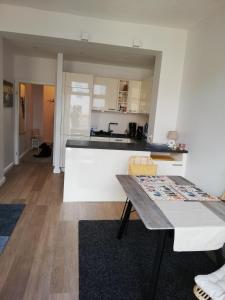 a living room with a table and a kitchen at Turmstrasse19 in Wismar