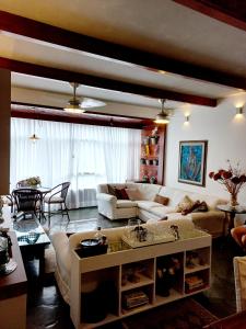a living room with a couch and a table at Apartamento Temporada Salvador in Salvador