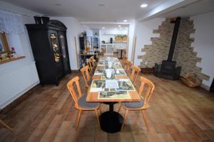 a dining room with a long table and chairs at Pension St. Moritz in Železná Ruda