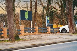 a white car parked in front of a fence at bp24 Hotel Eschweiler in Eschweiler