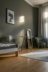 a bedroom with a bed and a chair at Moon Hostel Warszawa in Warsaw