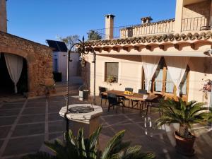 a patio of a house with a table and chairs at Pina in Pina