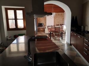 a kitchen with a sink and a table with chairs at Pina in Pina